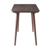 Side-facing view of contemporary walnut oak finish writing desk on white background