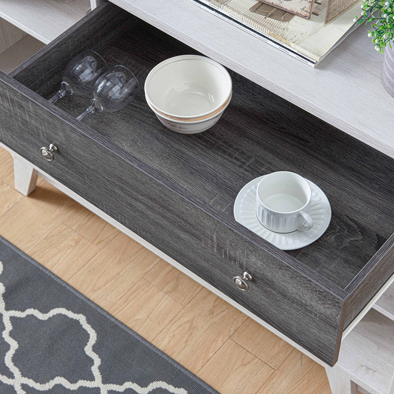 Cropped, angled view of mid-century modern distressed gray and white oak finish buffet server with one drawer open in living space with accessories