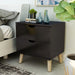 Left angled mid-century modern espresso nightstand with two drawers in a bedroom with accessories