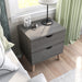Right angled top view mid-century modern distressed gray two-drawer nightstand with drawers open in a bedroom with accessories