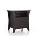 Right-angled espresso finished nightstand against a white background. Curved leg panels create a calming silhouette while silver knobs add a modern touch to the two drawers. An open shelf houses a slide-out tray.