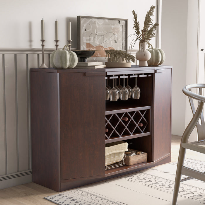 Right-angled vintage walnut wine bar cabinet in a traditional dining room.  The hanging stemware and trellis wine racks hold wine glasses and bottles. Fall pumpkin decor adorns the tabletop.