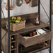 Right angled close up industrial reclaimed oak baker's rack with drawer open in a dining room with accessories