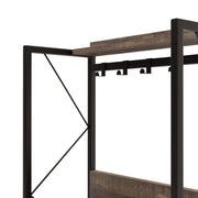 Left angled close up industrial reclaimed oak baker's rack detail of hanging hooks on a white background.