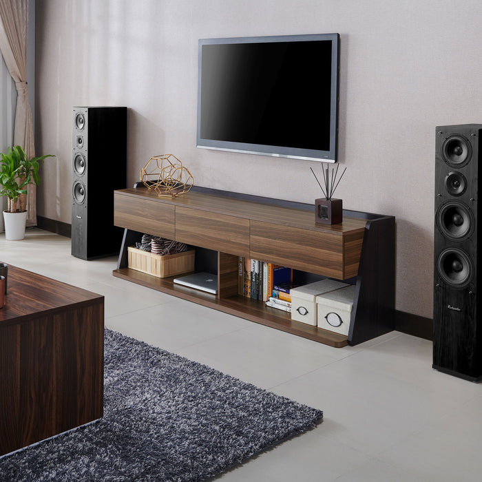 Left angled contemporary three-drawer light walnut and black TV stand in a living area with accessories