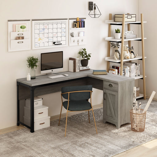 Right angled farmhouse vintage gray oak L-shaped desk in a home office with accessories
