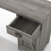 Left angled close up farmhouse vintage gray oak L-shaped desk open drawer detail on a white background