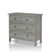 Left angled contemporary vintage gray oak three-drawer tall dresser on a white background
