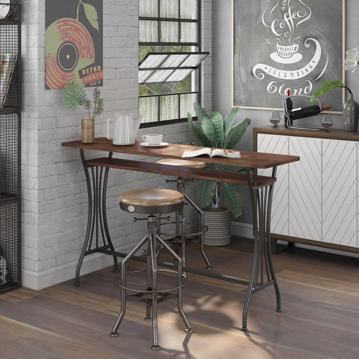 Left angled modern toasted barnwood and metal counter height table with a trestle base in a dining area with accessories