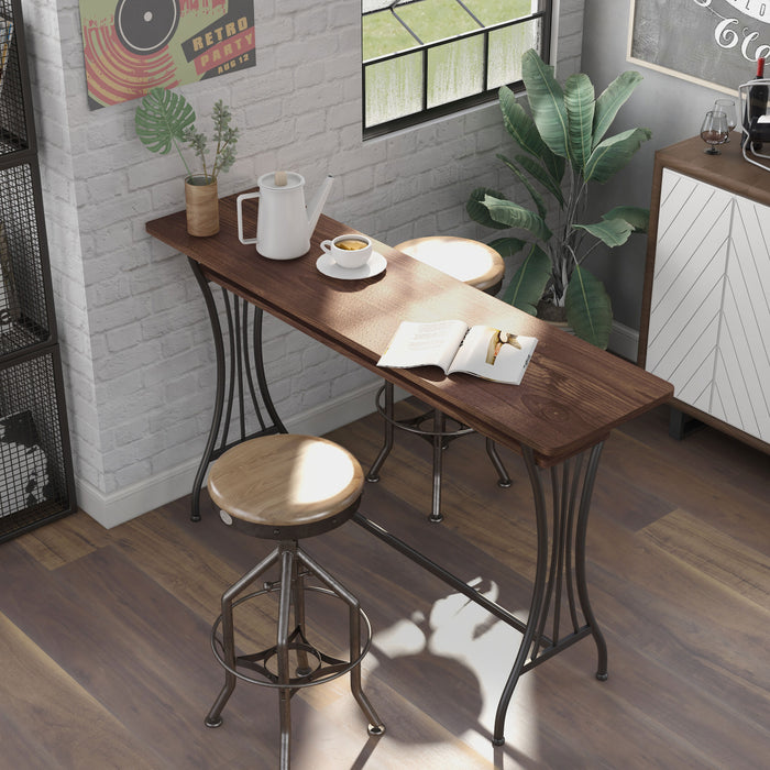 Left angled top view modern toasted barnwood and metal counter height table with a trestle base in a dining area with accessories