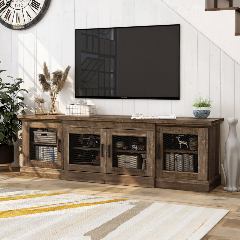 Left-angled rustic four-door TV stand with a reclaimed oak finish and metal mesh door inserts in a modern farmhouse living room with accessories