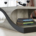 Left angled close up modern vintage gray oak wave coffee table shelf detail in a living room with accessories