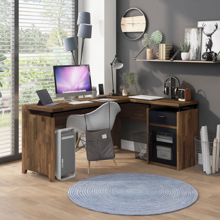 Right-angled light hickory L-shaped desk in an urban home office. The desktop holds electronic devices, a table lamp, and plants. Beneath the desk is a computer and a black wire mesh trash bin to match the cabinet. 