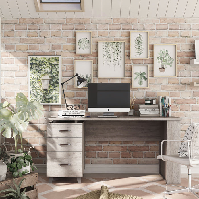 Front-facing transitional coastal white office desk with three drawers in a home office with accessories