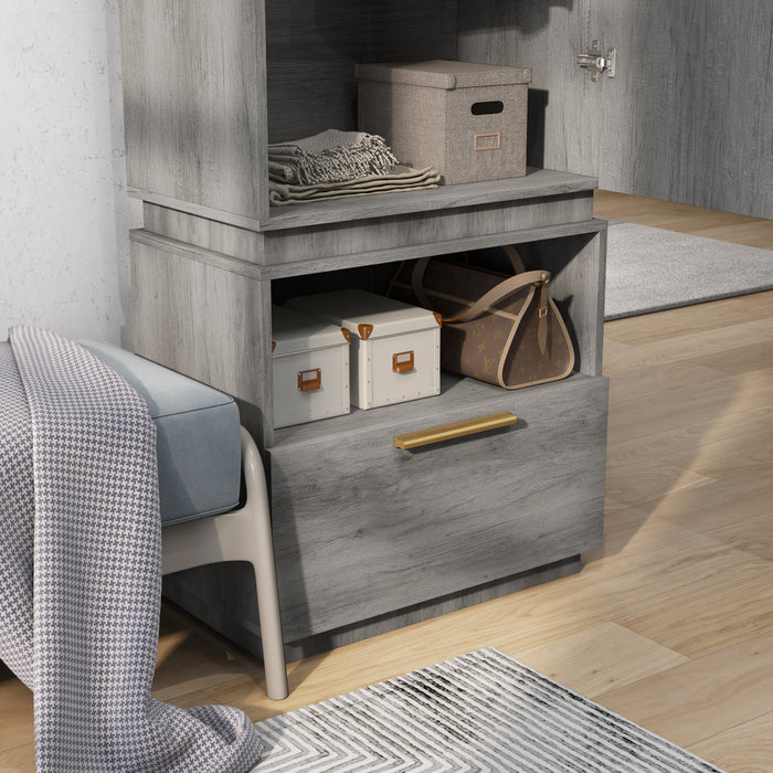 Left angled close up drawer and shelf of amoire with mirror in a vintage gray oak finish in a room with accessories