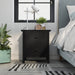Front-facing transitional two-drawer black nightstand in a bedroom with accessories