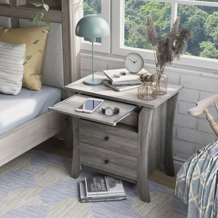 Left-angled transitional vintage gray oak finish wood two-drawer nightstand with flared sides, one fixed shelf, and one pulled-out shelf in a modern farmhouse bedroom with accessories