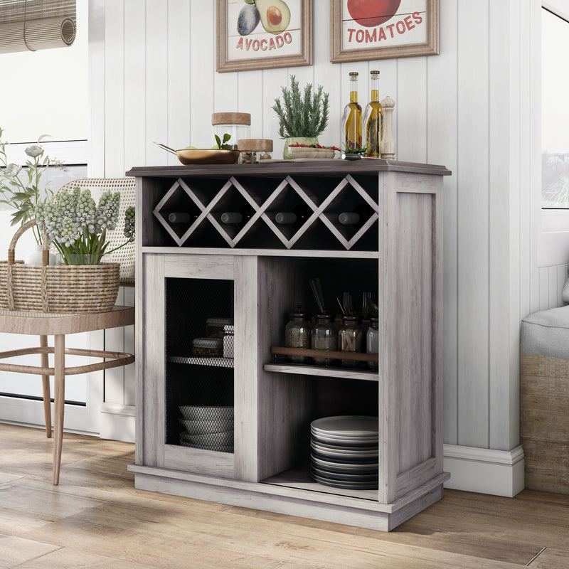 Left-angled coastal white wine buffet against a white shiplap wall. Oils and herbs present themselves on the tabletop while the lattice wine rack holds four bottles. Behind the iron-mesh accented cabinet door are dishes. To the left of the server is a natural cane chair holding a basket of lavender. Above the sideboard two framed signs showcasing avocado and tomatoes.