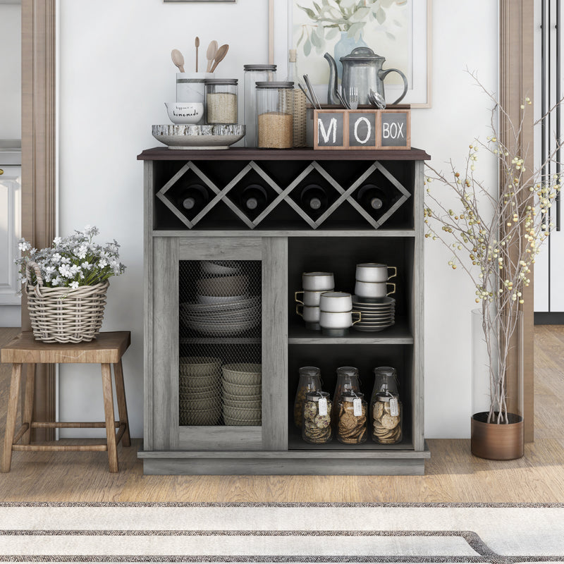 Front-facing vintage grey oak wine buffet against a white wall. Baking supplies present themselves on the tabletop while the lattice wine rack holds four bottles. On the open shelves are dishes and cookie jars. To the left of the server is a stool holding a basket of flowers.