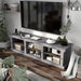 Left angled top view industrial six-shelf cement TV stand in a living room with accessories