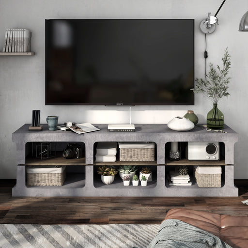 Front-facing industrial six-shelf cement TV stand in a living room with accessories