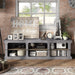 Front-facing industrial six-shelf cement TV stand in a living room with accessories