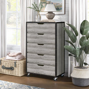 Left angled five drawer dresser in a vintage gray oak finish in a room with accessories