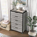 Left angled five drawer dresser in a vintage gray oak finish in a room with accessories