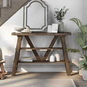 Front facing two shelf console table in a reclaimed oak finish in a room with accessories