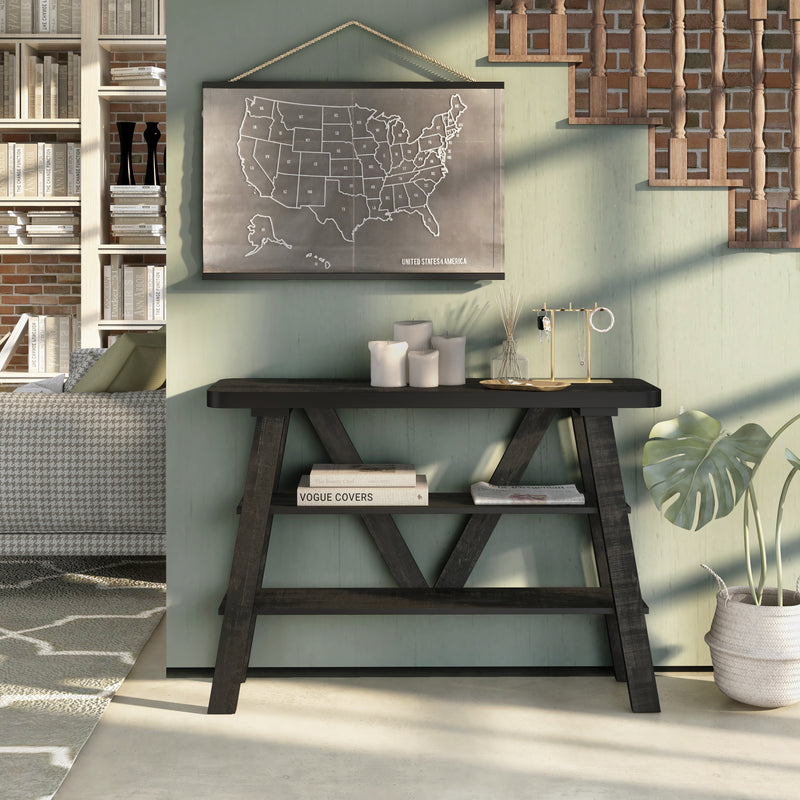 Front facing two shelf console table in a reclaimed black oak finish in a room with accessories