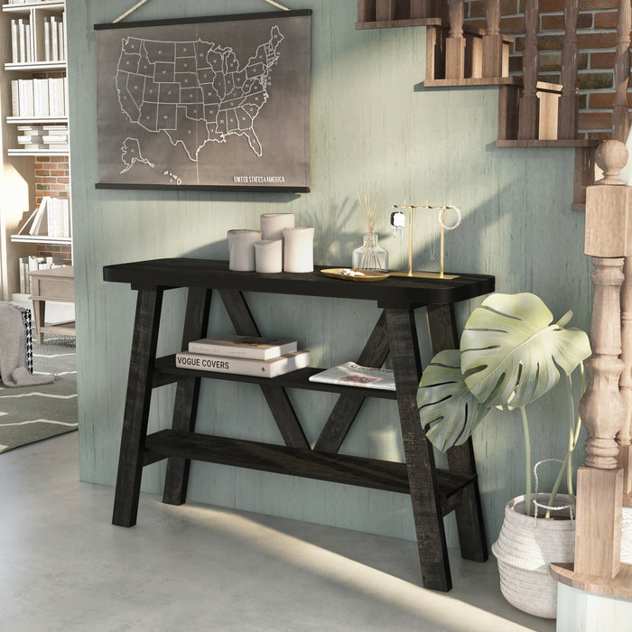 Left angled two shelf console table in a reclaimed black oak finish in a room with accessories