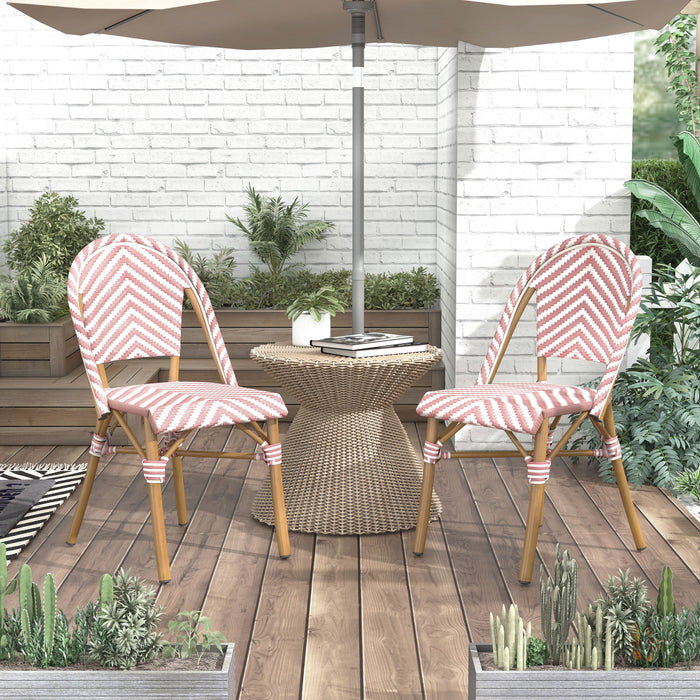 Pink and white chevron patterned chairs under an umbrella in a boho patio.