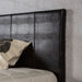 Left-angled, detail shot of the brown faux crocodile leather headboard.
